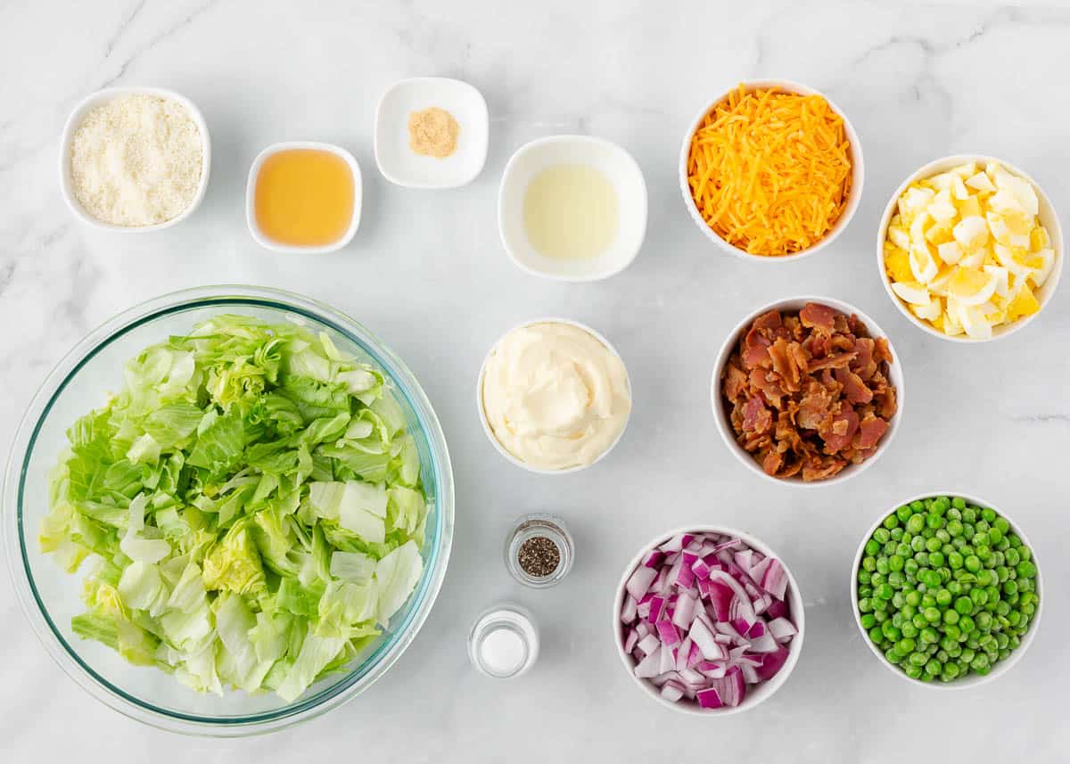 7 layer salad ingredients on a marble counter.