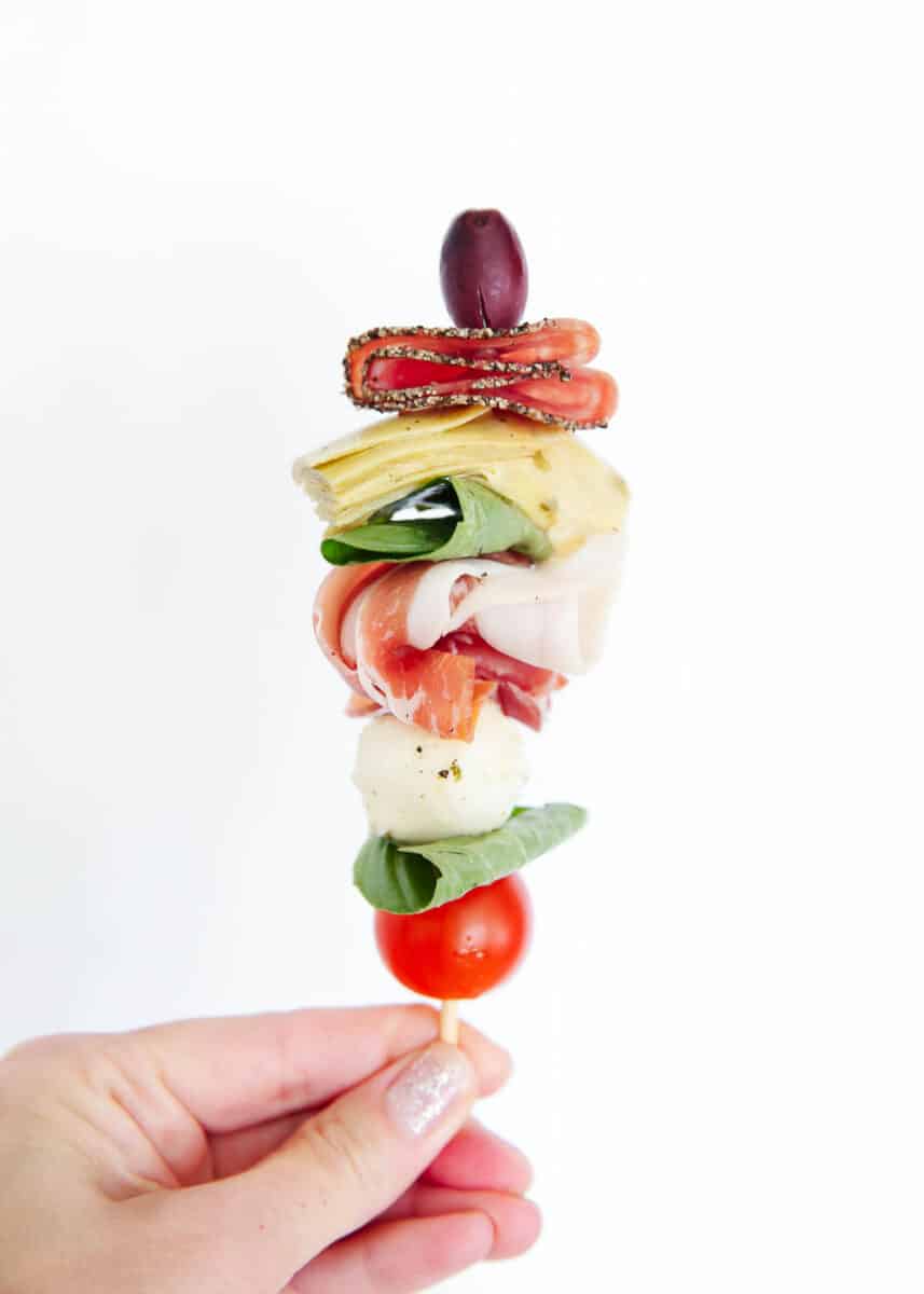 Holding an antipasto skewer.