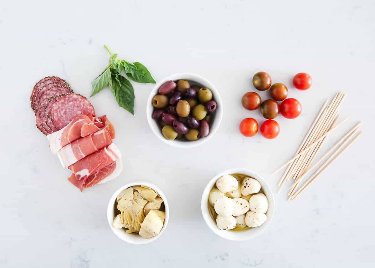 Antipasto skewers on the marble countertop.