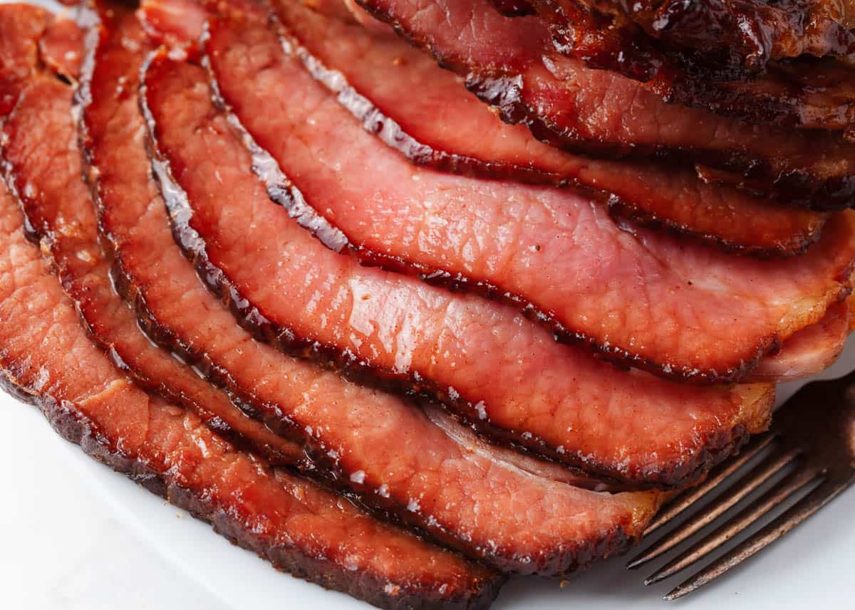 Sliced baked ham on a plate.