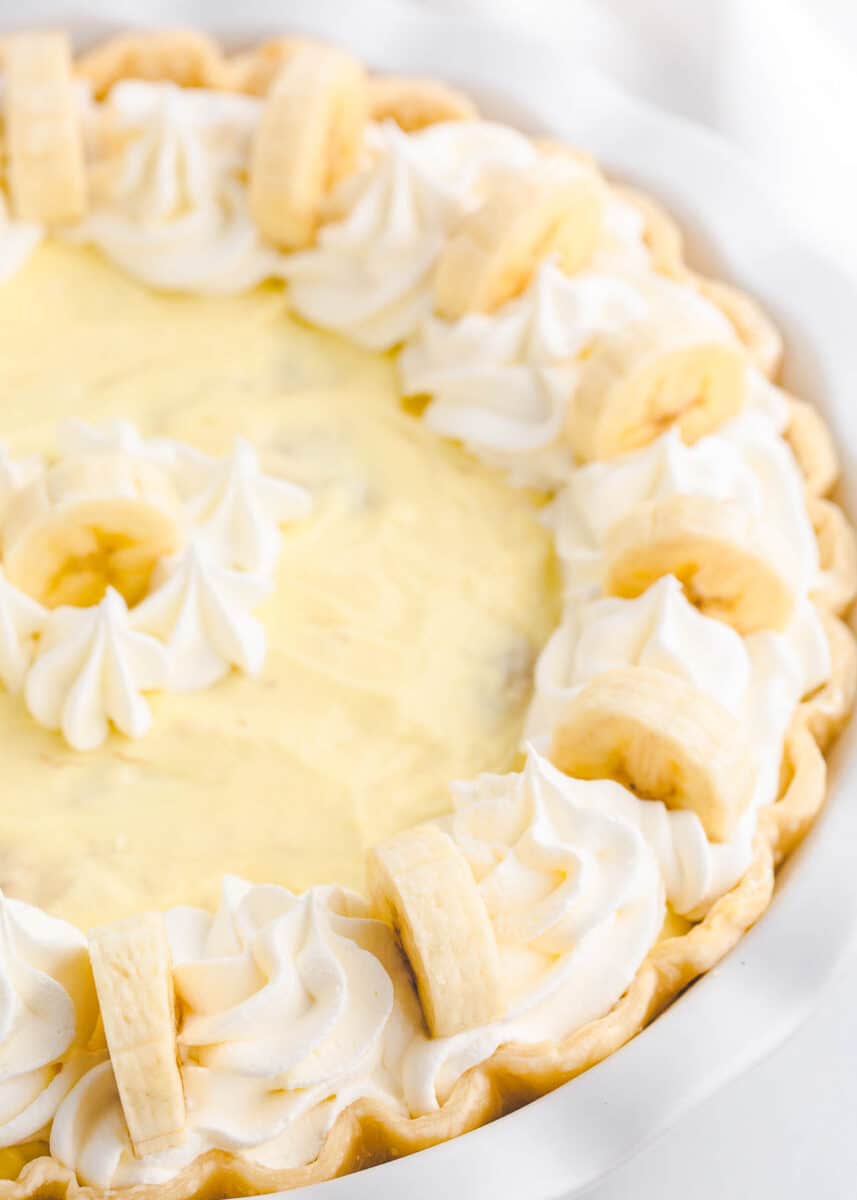 Banana cream pie in white dish.