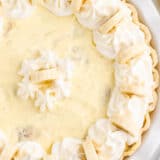 Banana cream pie in white pie dish.