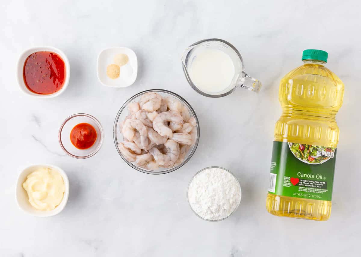 Bang bang shrimp ingredients on a marble counter.