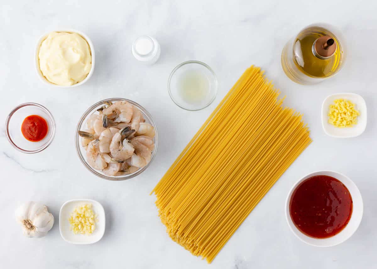 Bang bang shrimp pasta ingredients on a marble counter.