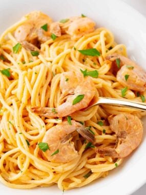 Bang bang shrimp pasta in a white bowl.