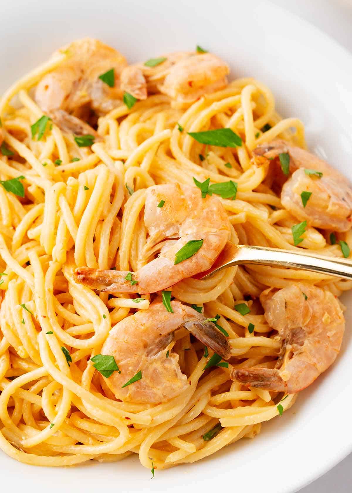 Bang bang shrimp pasta in a white bowl.