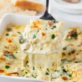 Slice of white chicken lasagna in pan.