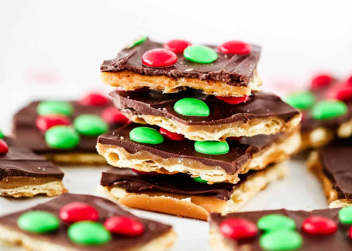 Christmas crack stacked on a white plate.