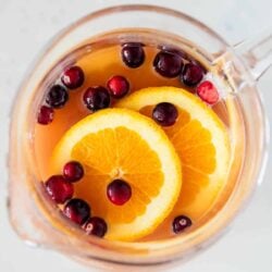 Christmas punch in a glass pitcher.