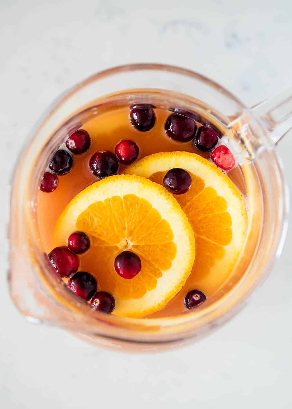 Christmas punch in a glass pitcher.