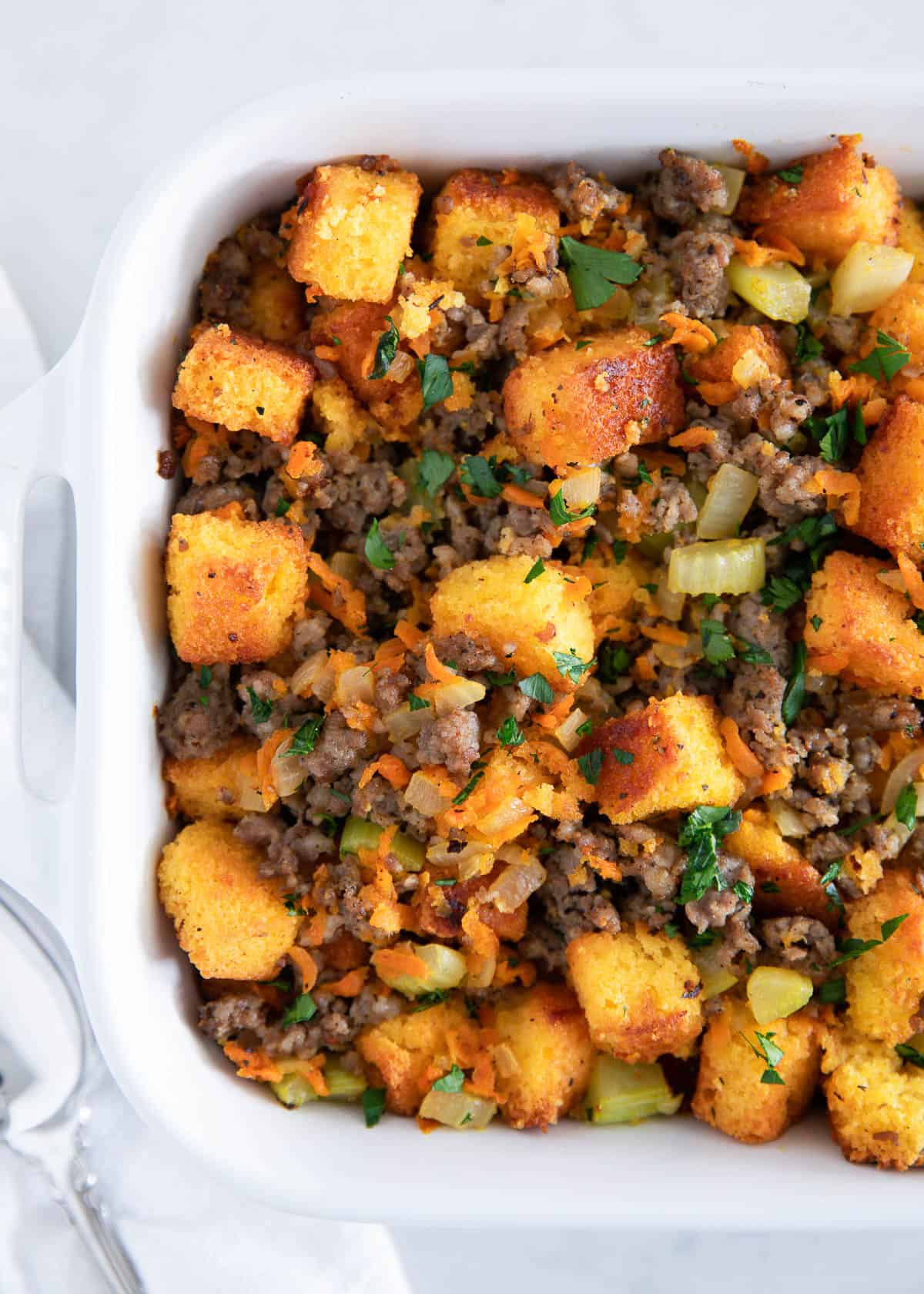 Cornbread stuffing in a white baking dish.