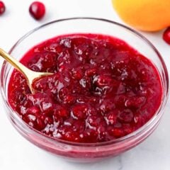 Cranberry sauce made with only 3 ingredients in a glass bowl with spoon.