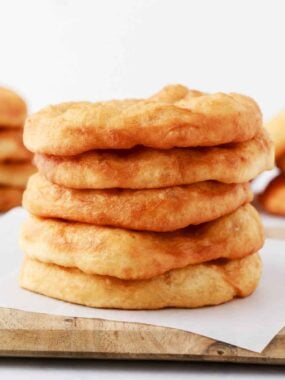 Stack of fry bread on cutting board.