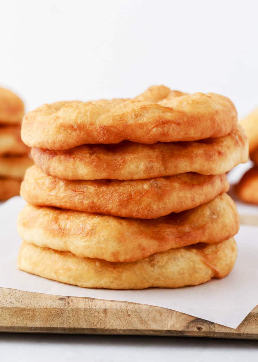 Stack of fry bread on cutting board.