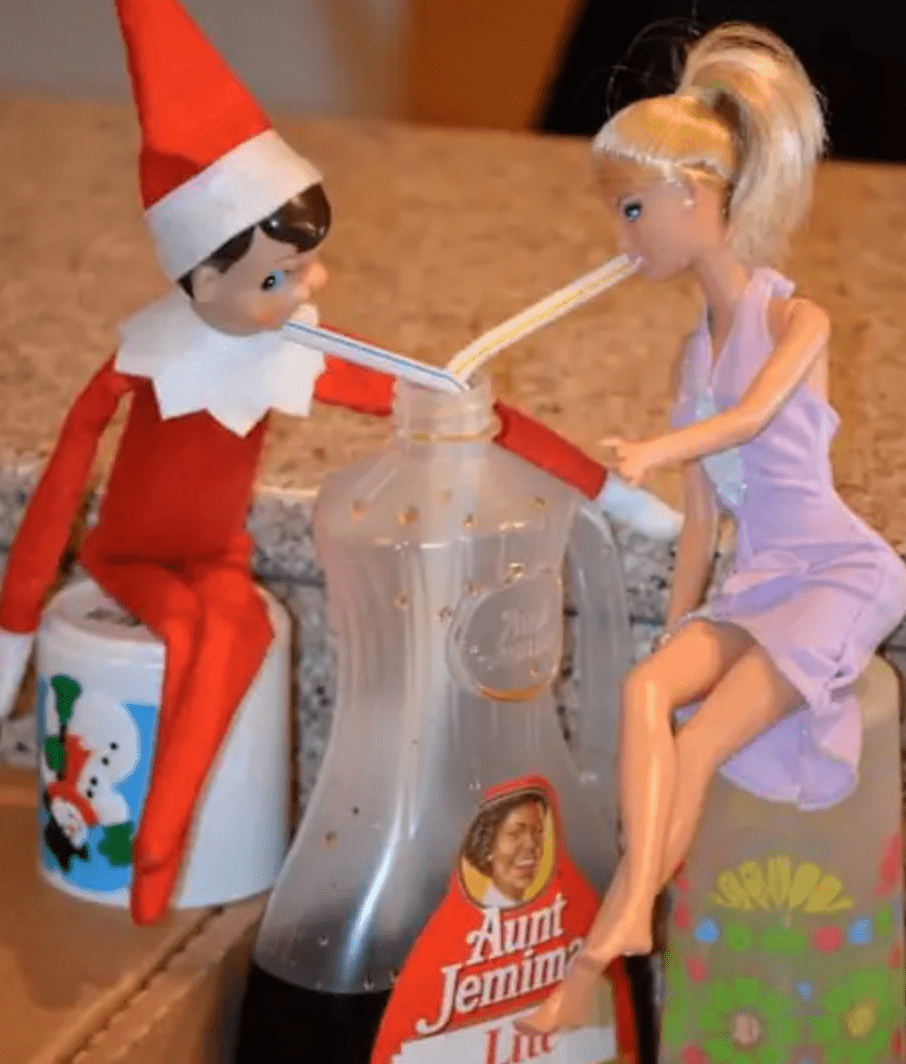 Elf and barbie sipping syrup with a straw,