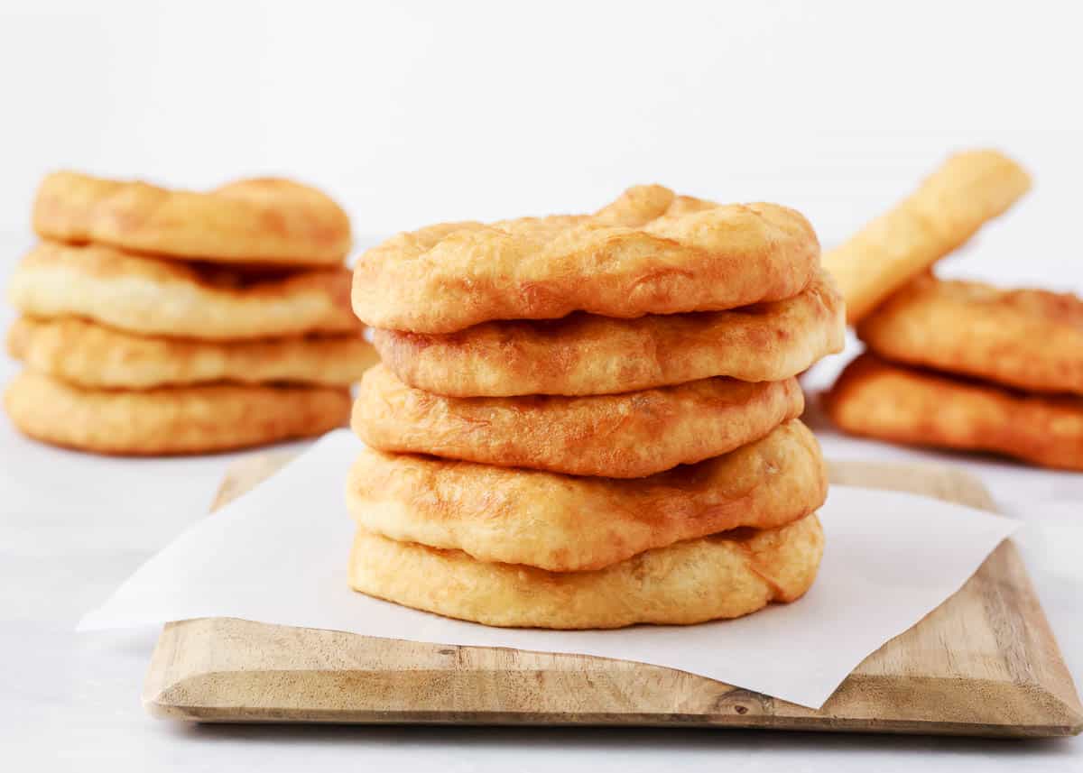 Stack of fry bread on cutting board.