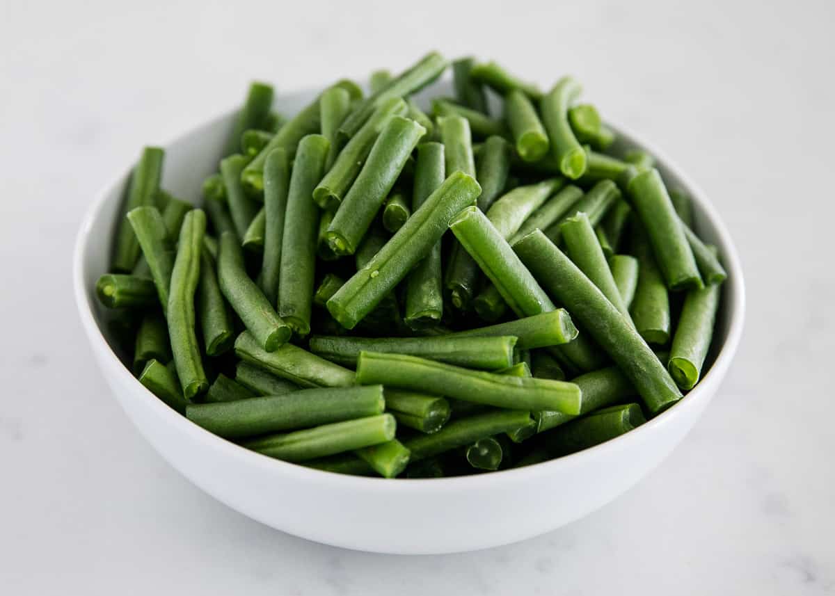 Green beans in a white bowl.