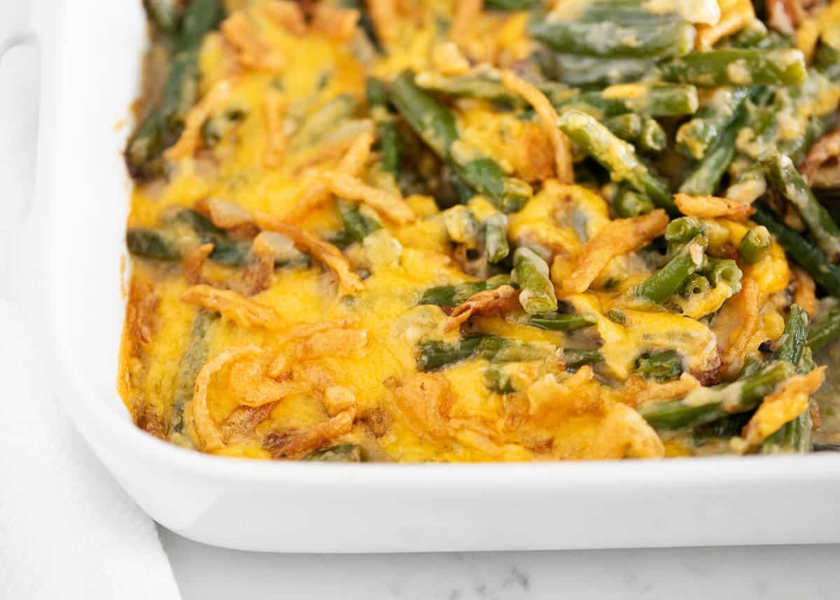 Green bean casserole cooked in a white baking dish.