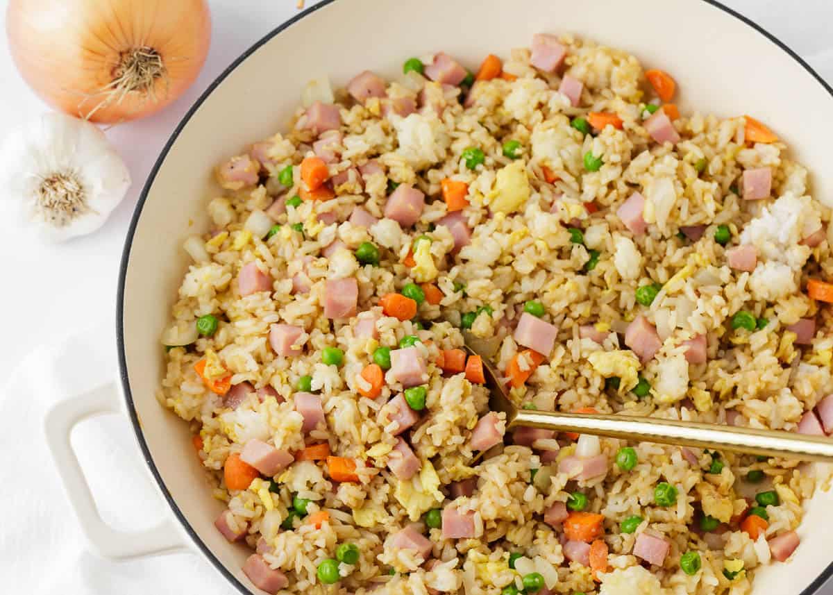 Ham fried rice cooked in a white pot.