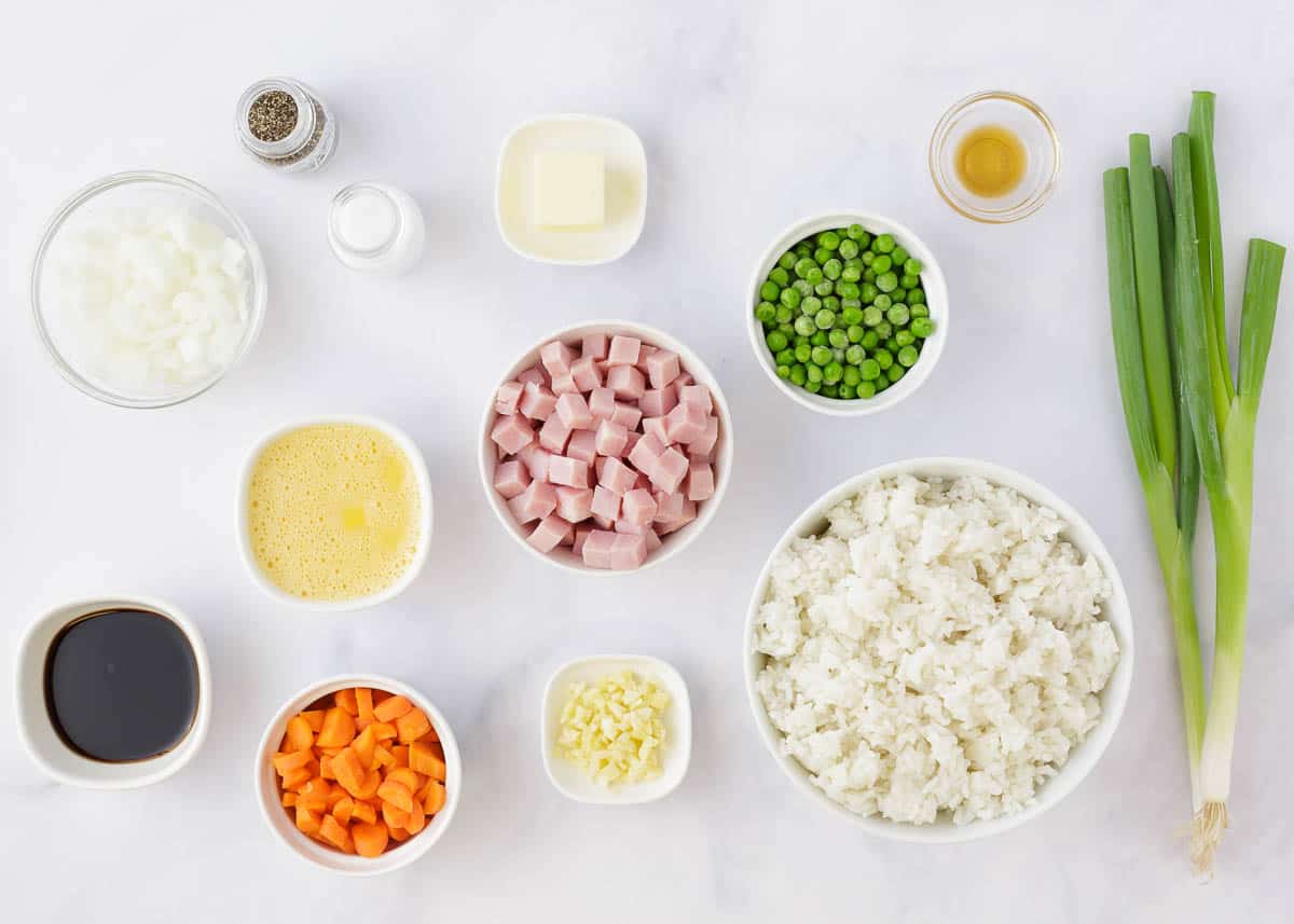 Ham fried rice ingredients on marble countertop.