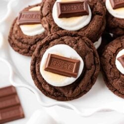 Hot chocolate cookies on a white cake plate.