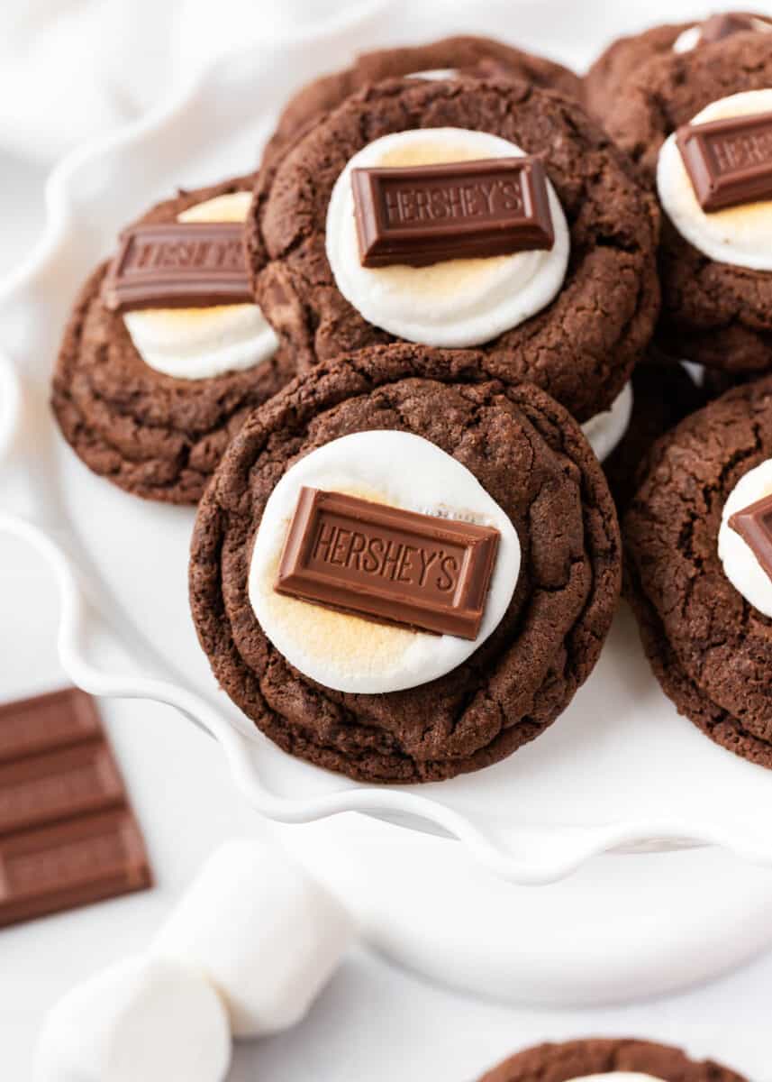 Hot chocolate cookies on a white cake plate.