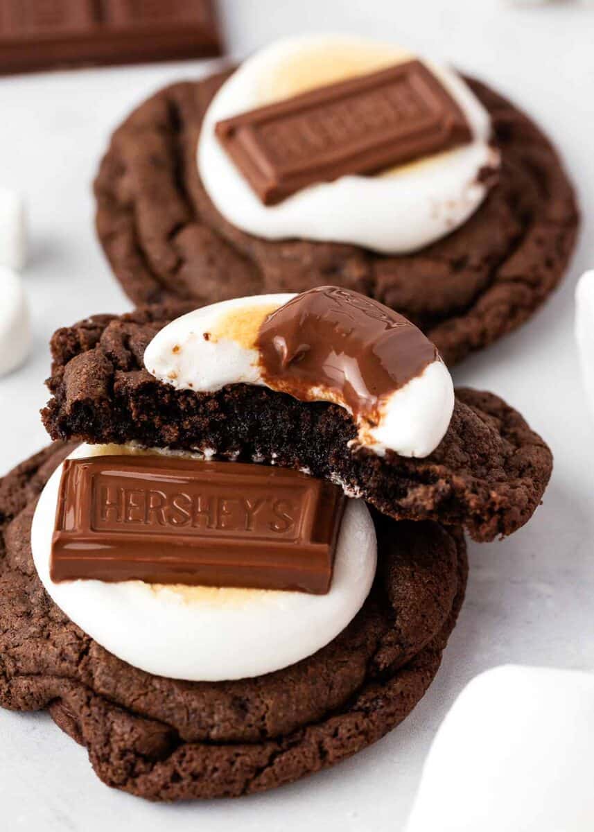 Hot cocoa cookies with a marshmallow and chocolate on top.