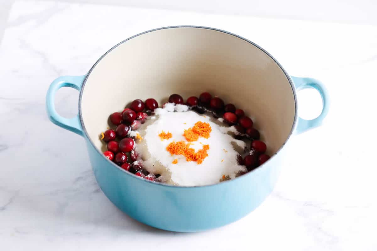 Showing how to make cranberry sauce in a pot.