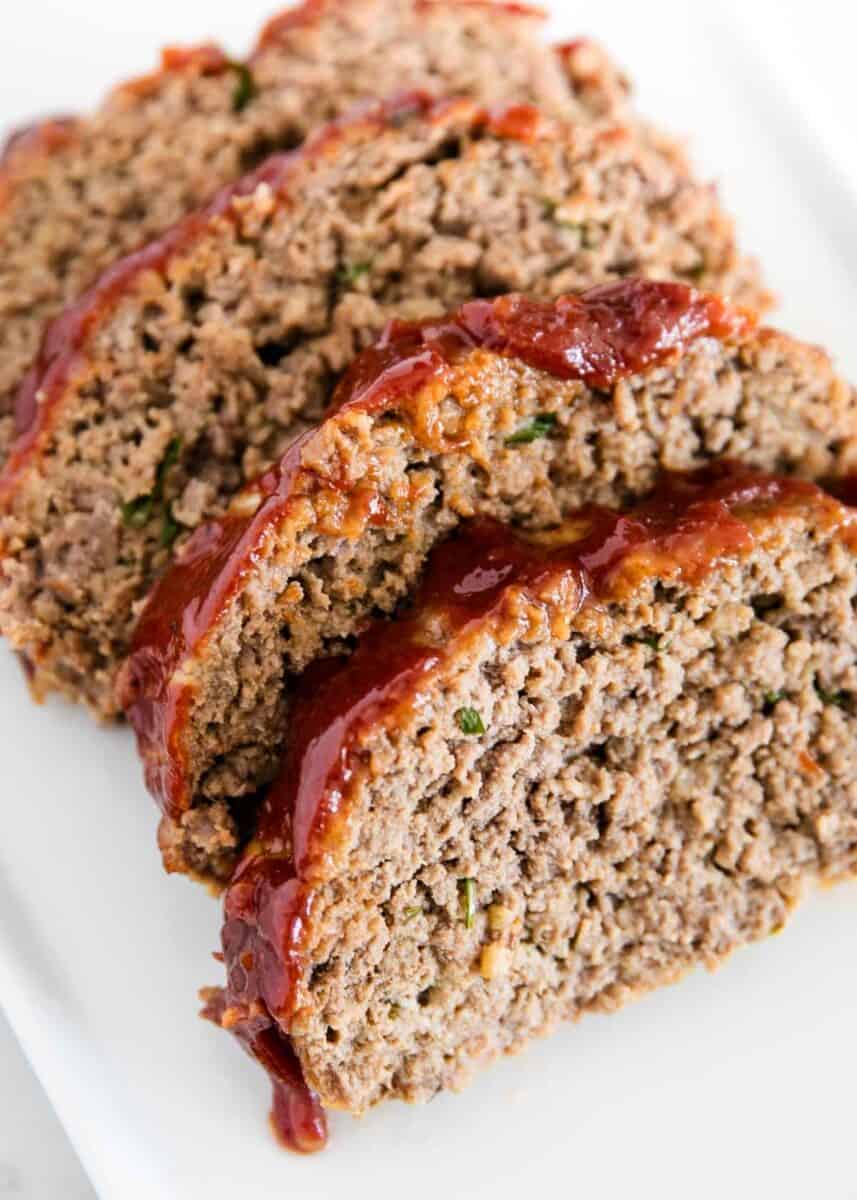 Sliced meatloaf on a white plate.