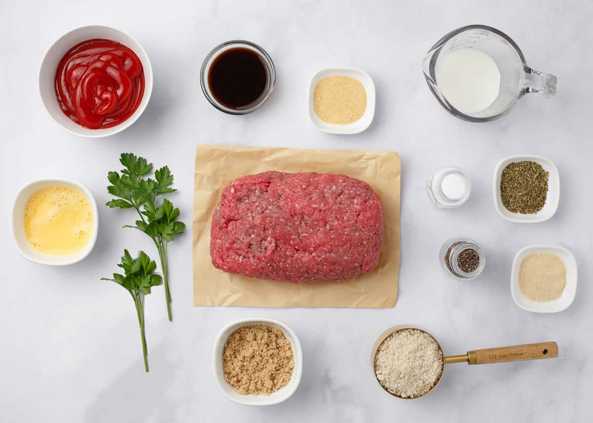 Meatloaf ingredients on marble countertop.