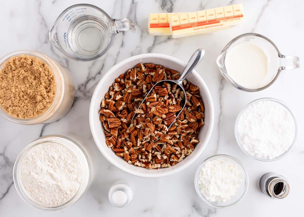 Pecan pie bar ingredients on marble counter.