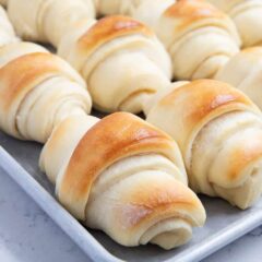 Soft and tender potato rolls with instant potato flakes baked on metal baking sheet.