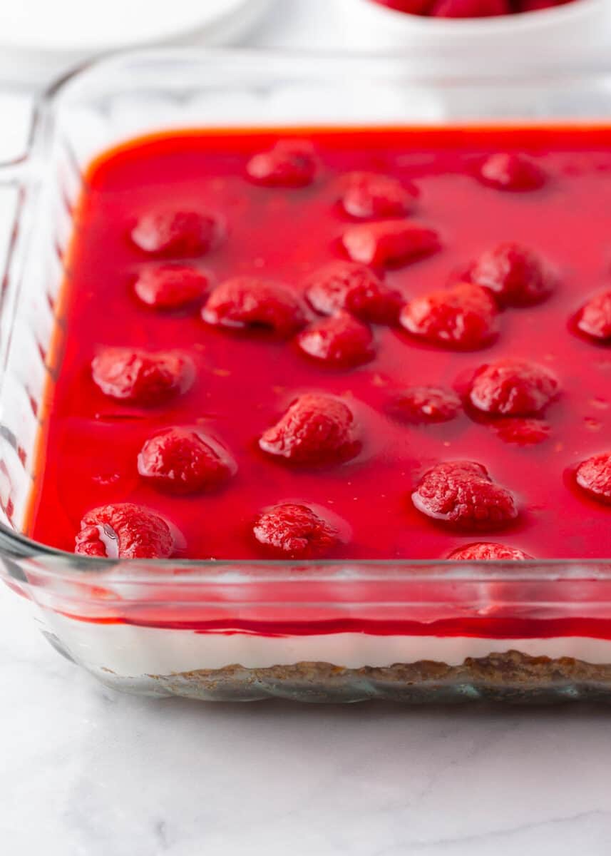 Raspberry pretzel salad in a glass baking dish.