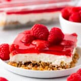 Slice of raspberry pretzel salad on a white plate.