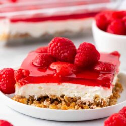 Slice of raspberry pretzel salad on a white plate.