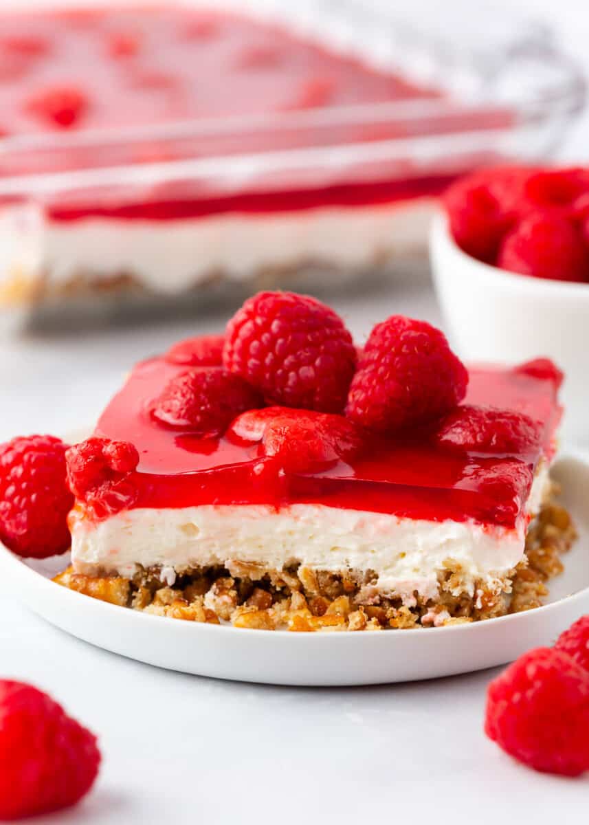 Slice of raspberry pretzel salad on a white plate.