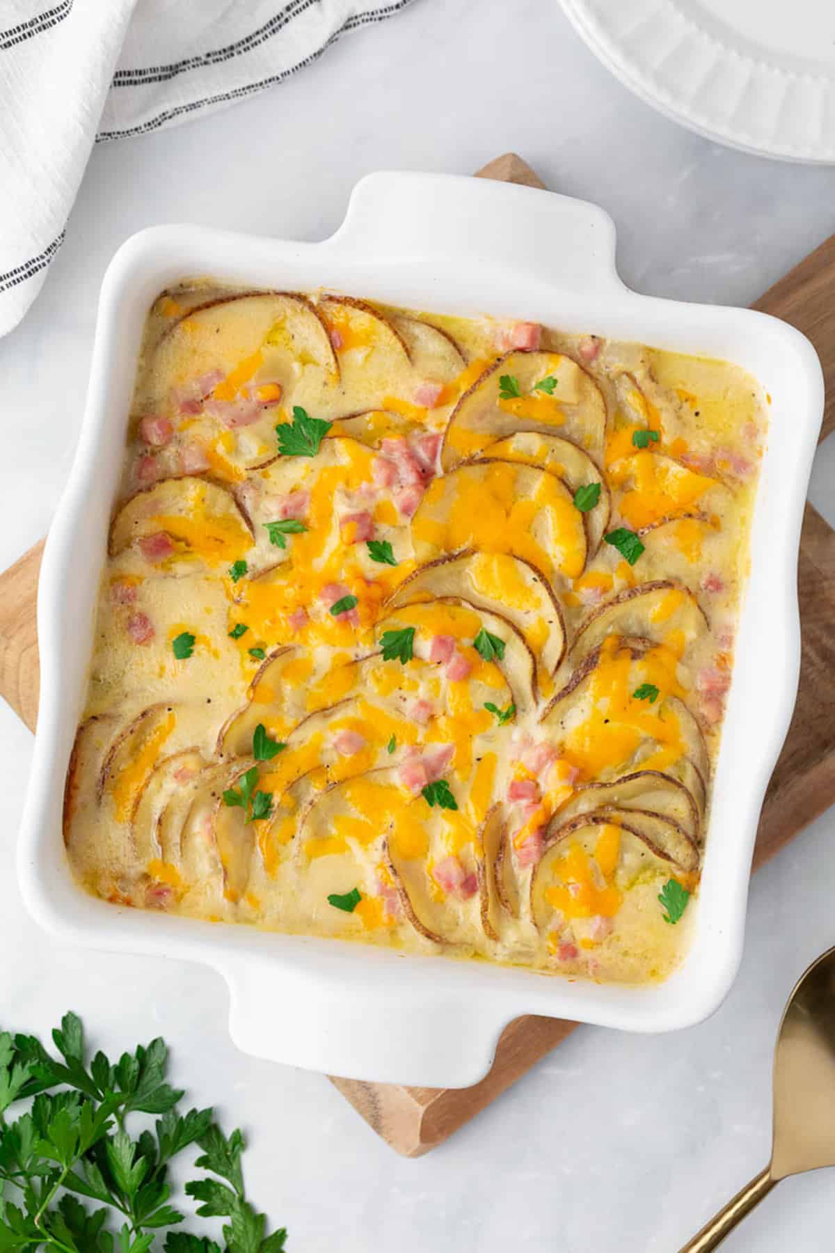 Scalloped potatoes and ham in baking dish.