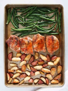 Sheet pan pork chops with potatoes and green beans.