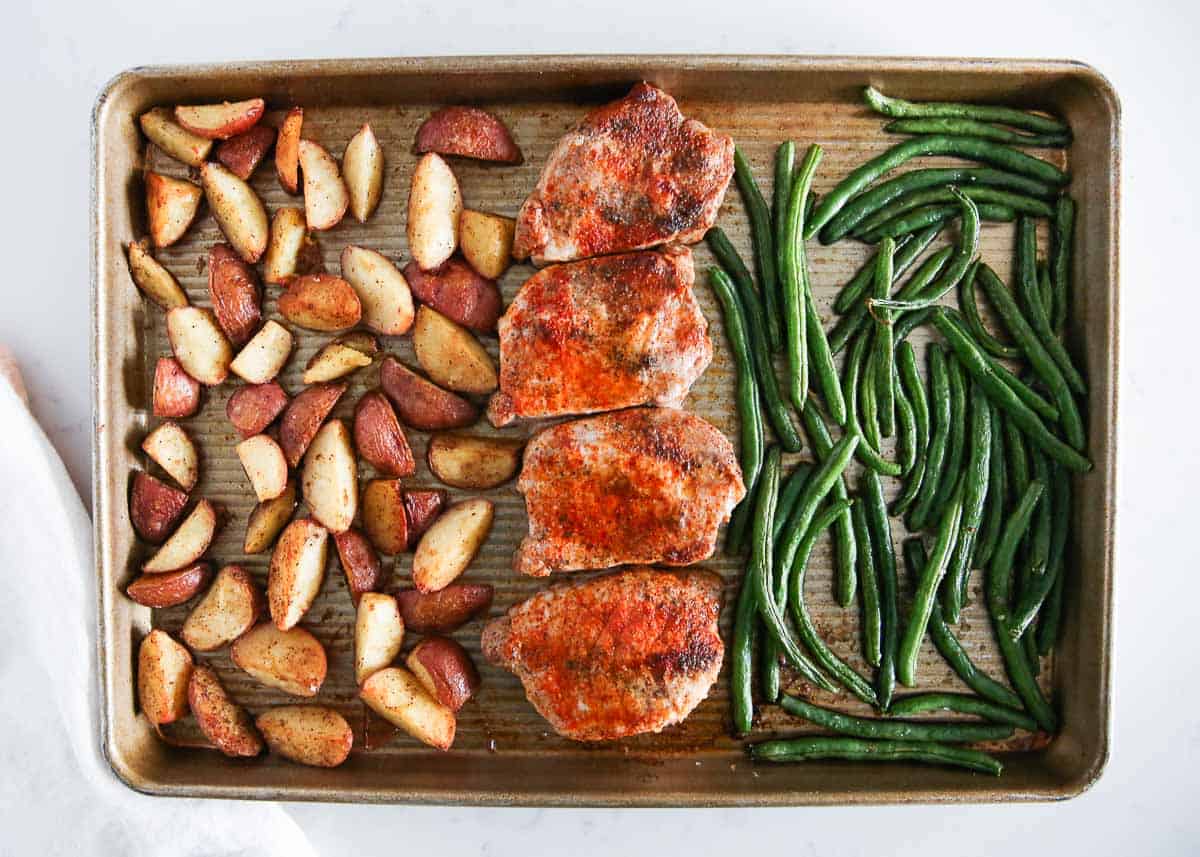 Sheet pan pork chops with potatoes and green beans.