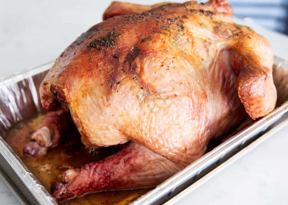 Smoked turkey on counter in metal pan.