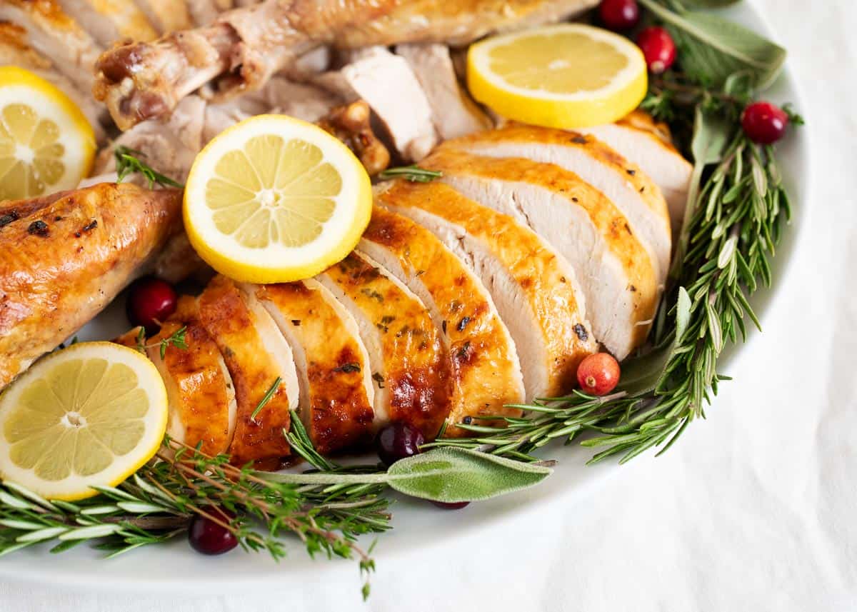 Sliced smoked turkey on a white plate.