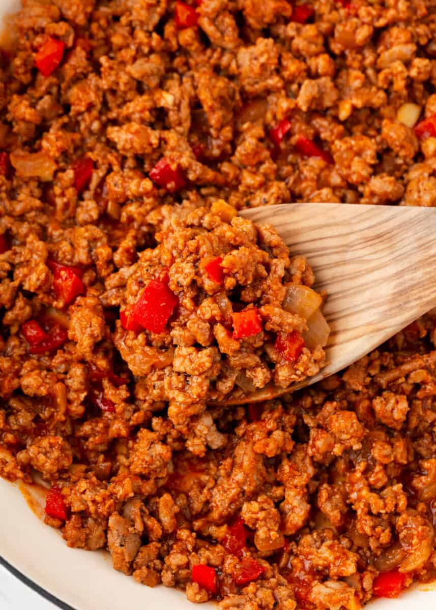 Turkey Sloppy Joes Mixture in pot with wooden spoon.