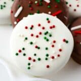 White chocolate covered oreos with sprinkles on top.
