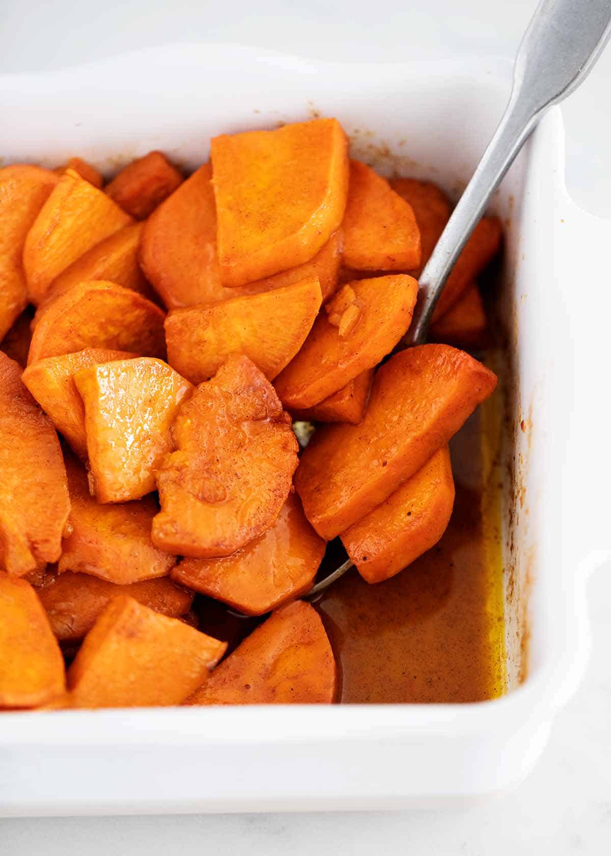 Candied yams in white baking dish.