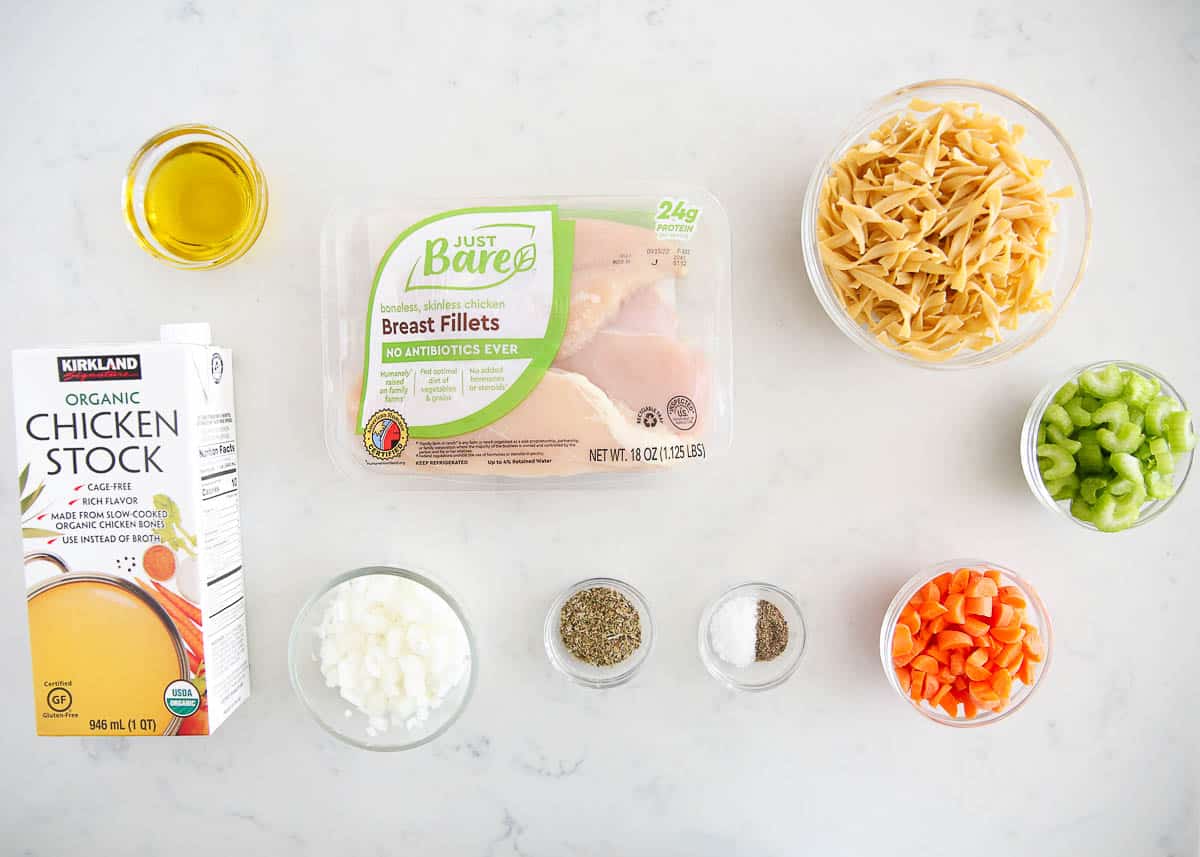 Chicken noodle soup ingredients on countertop.