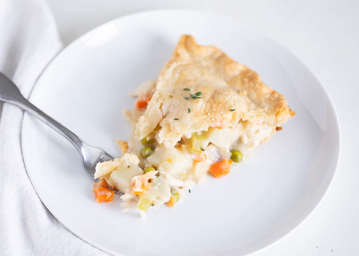 Slice of turkey pot pie on a white plate.