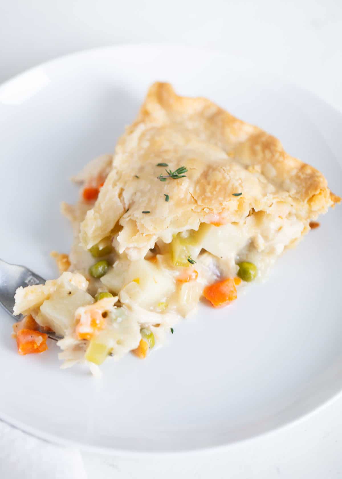 Slice of turkey pot pie on a plate.