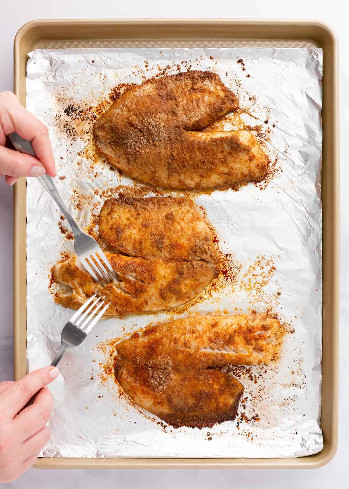 Baked tilapia on a sheet pan. 