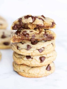 Chocolate chip cookies stacked on a counter.