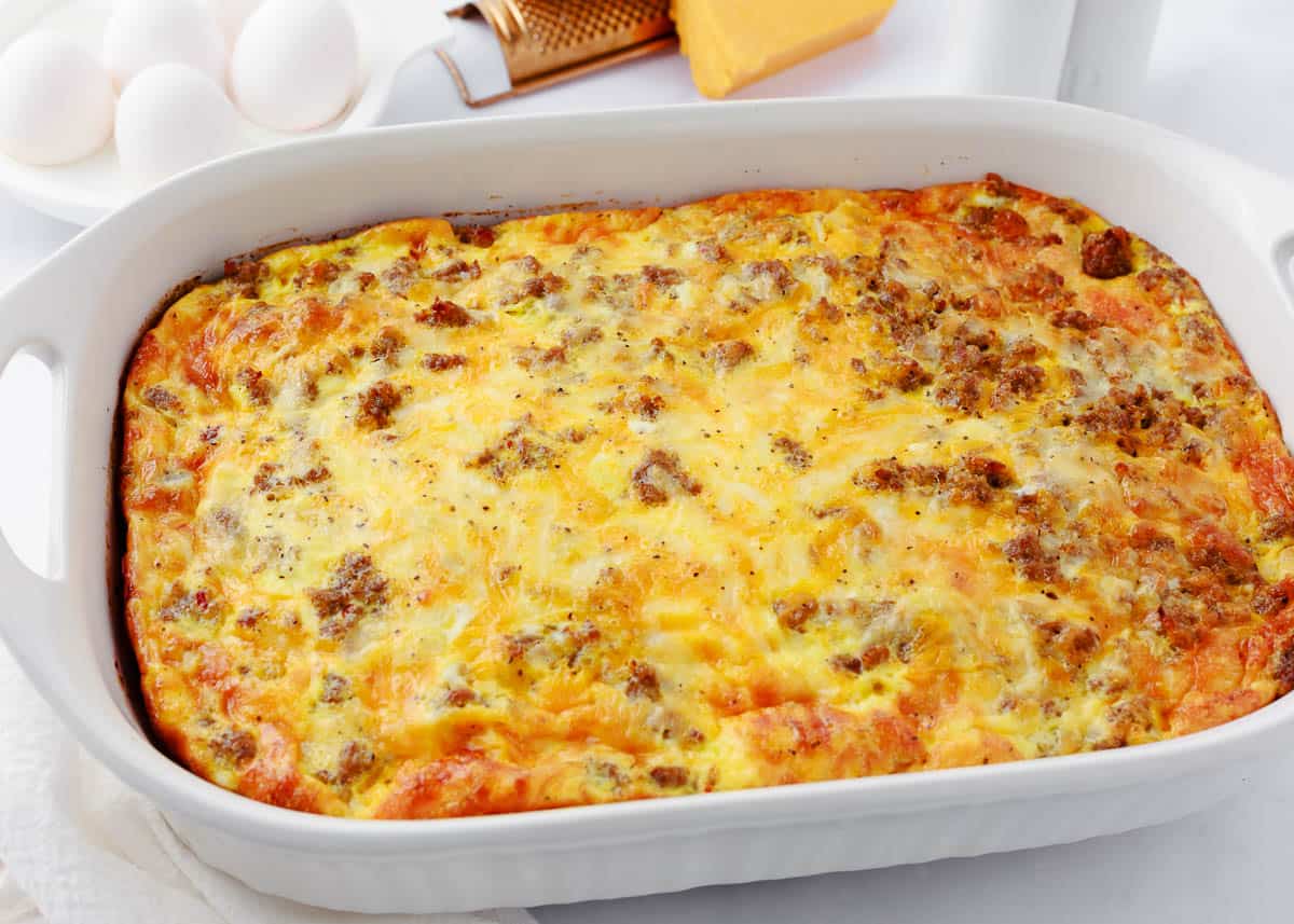 Breakfast biscuit casserole in a white baking dish.